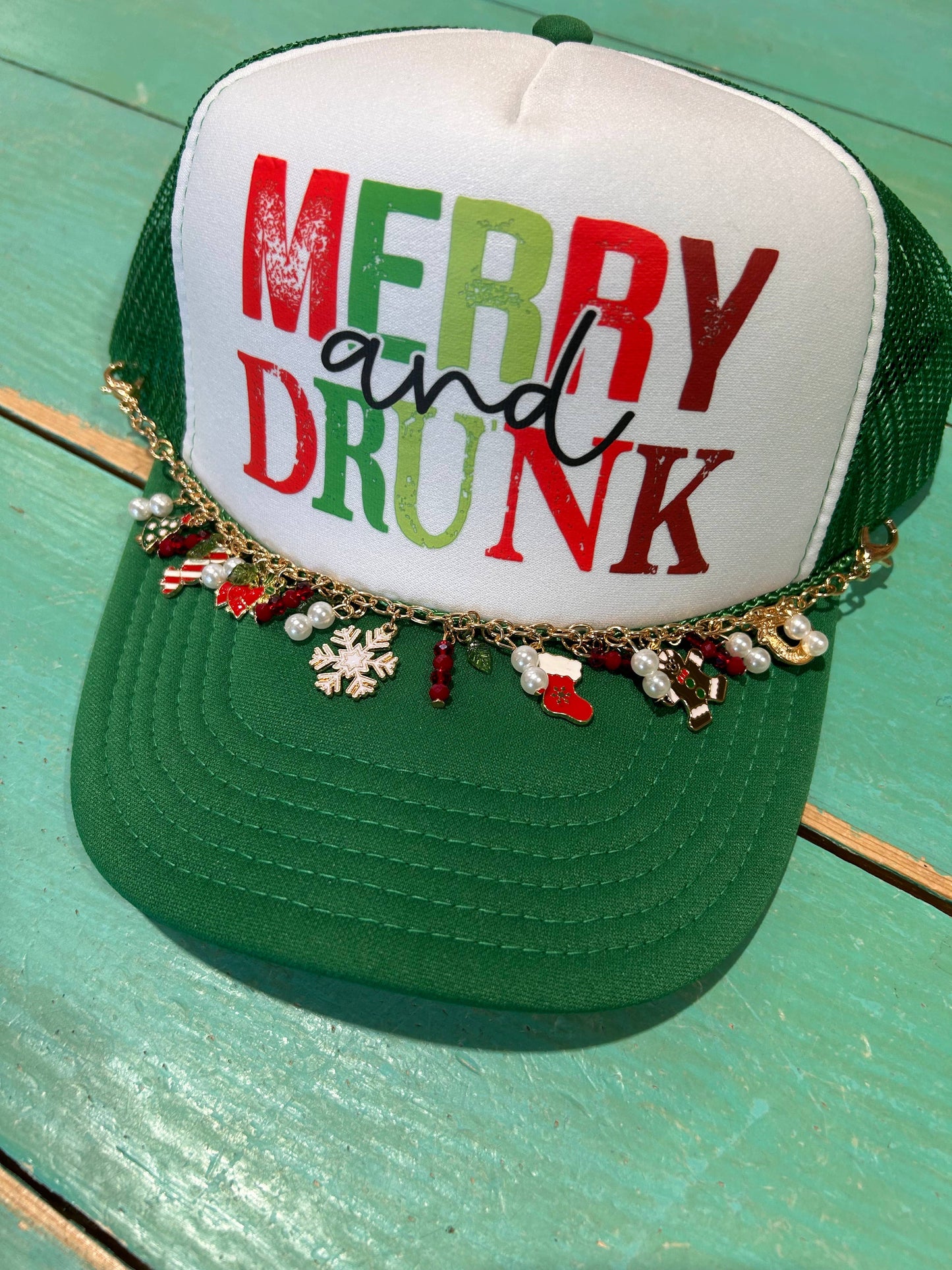 Perfect for celebrating the season! Merry and Drunk Christmas Trucker Hat includes Christmas Chain